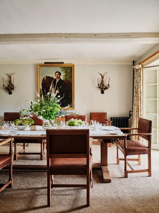 In the dining room Robert Kime sourced the antler sconces. The painting was a gift to Hugo from Karl Lagerfeld. The old...