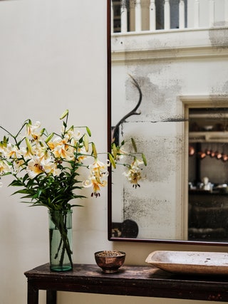 The mirror was bought from the Emma Hawkins sale at Sotheby's. The lilies were grown in the garden.