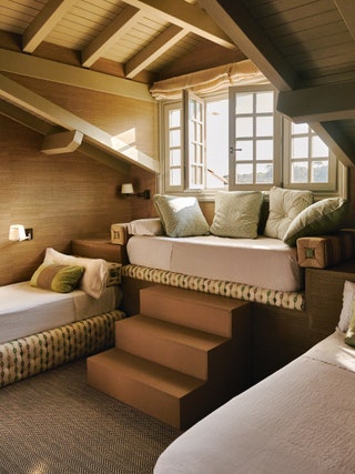 An earthy scheme is established with a raffia wallcovering from Lorenzos own collection and bed bases in a Sanderson print.