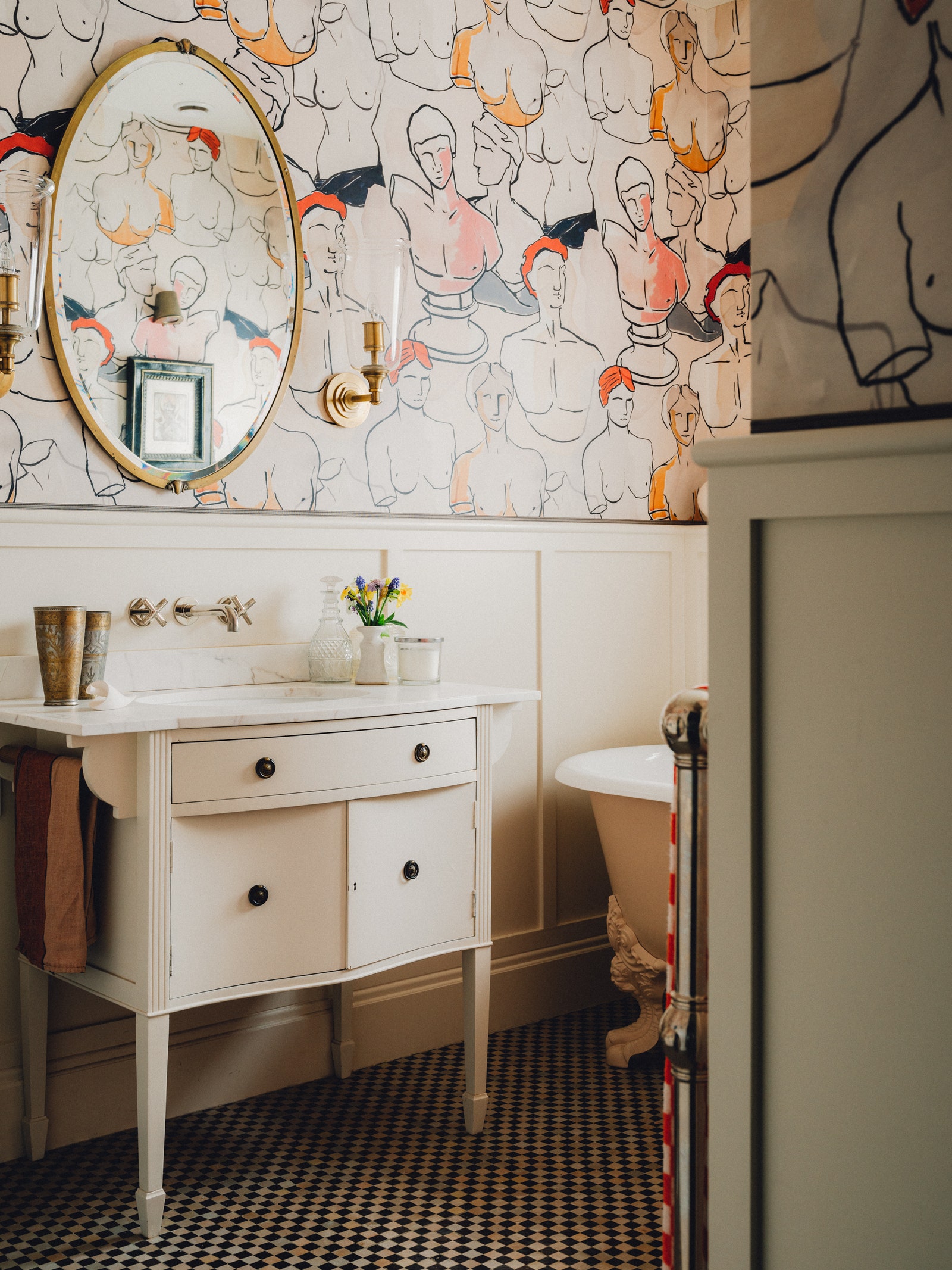 In lieu of overhead lighting opt for more decorative warm lights such as these two from Waterworks either side of the...